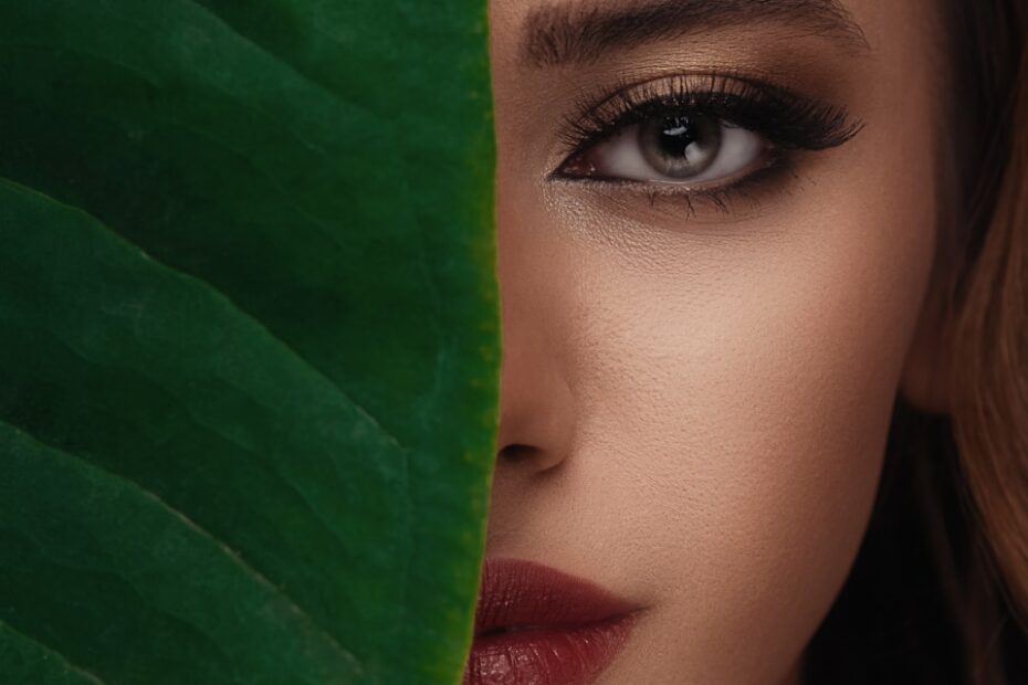 woman in red lipstick beside green textile